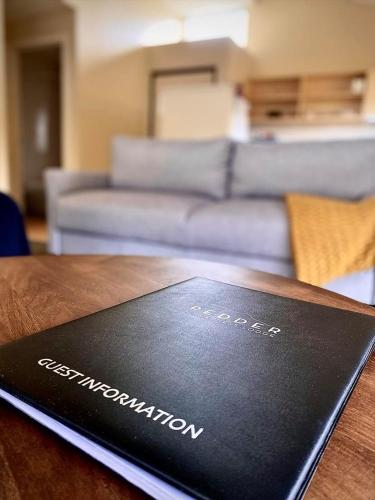 a book sitting on top of a wooden table at Pedder Wilderness Lodge in Strathgordon