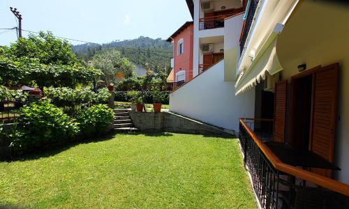 a balcony of a building with a grass yard at Nama Apartments in Skala Potamias