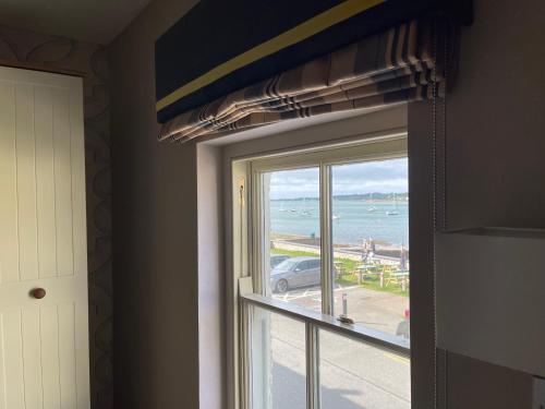 a window in a room with a view of the ocean at Garddfon Inn in Y Felinheli