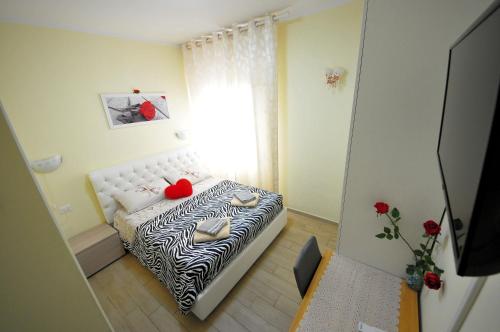 a small room with a zebra print bed with a window at Affittacamere Lidiya in Bologna