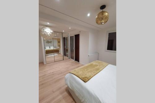 a bedroom with a white bed and a mirror at Nid d'amour baignoire/jacuzzi in Nice