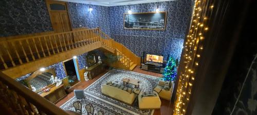 an aerial view of a living room with a christmas tree at Family holiday home. in Qusar