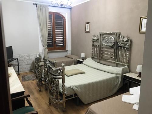 a bedroom with a bed and a clock on the wall at IL TUCANO in Pergusa