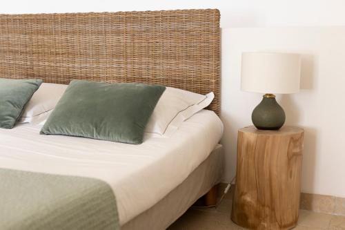 a bedroom with a bed and a lamp on a table at Mas de Capelou in Avignon