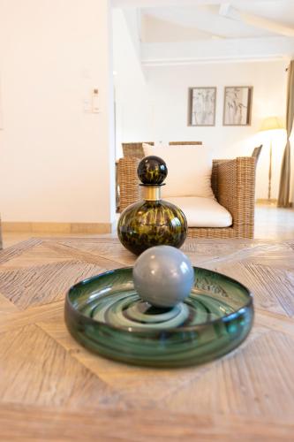 a glass vase and a ball on a table at Mas de Capelou in Avignon