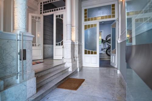 a hallway of a home with white doors and stairs at Garden of Eden in Antwerp