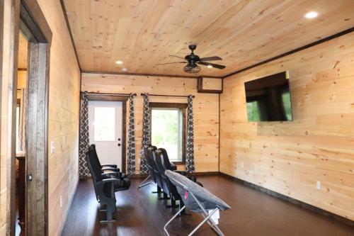 a room with chairs and a ceiling fan at Chalet Village- Amazing Mountain Views - Piney Butt Place in Gatlinburg