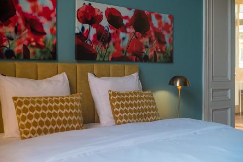 a bedroom with a bed with red flowers on the wall at Garden of Eden in Antwerp