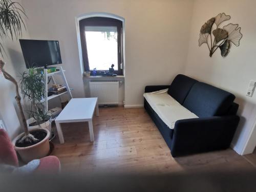 a living room with a couch and a table at Im Herzen des Kraichgaus 1 in Östringen