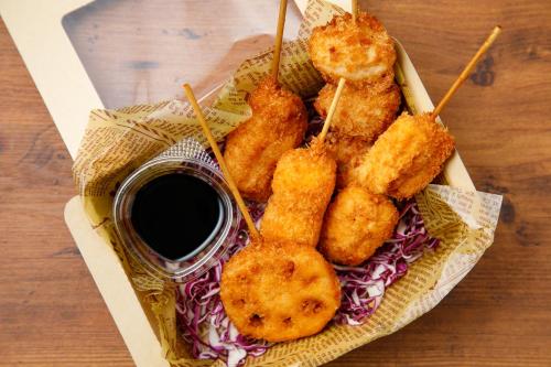 a tray of food with onion rings and dipping sauce at Shin Osaka Esaka Tokyu REI Hotel in Suita