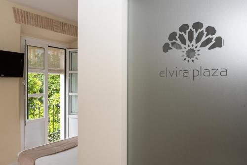 a logo on the wall of a room at Hotel Boutique Elvira Plaza in Seville