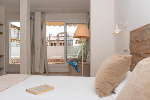 a bedroom with a bed and a view of a building at Hotel Boutique Elvira Plaza in Seville