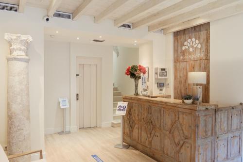 a room with a counter with a vase of flowers on it at Hotel Boutique Elvira Plaza in Seville