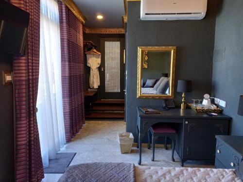a room with a mirror and a desk with a bed at Julina Boutique Living in Mosta
