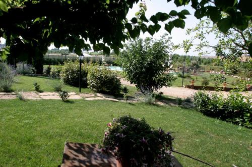 a garden with green grass and flowers in a park at Agriturismo Renaccino in Siena