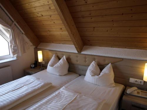 a bedroom with two beds in a wooden ceiling at Airport Hotel Filder Post in Stuttgart