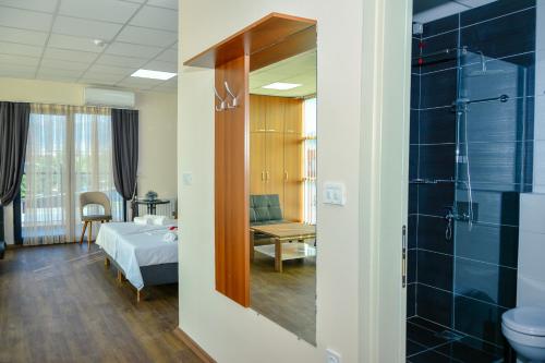 a hospital room with a bed and a bathroom at Hotel Story in Skopje
