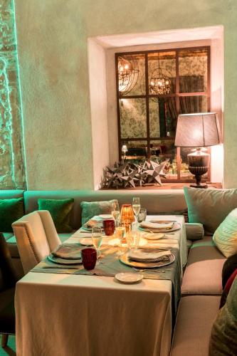 a table with plates and wine glasses on it at La Barchessa di Villa Pisani in Lonigo