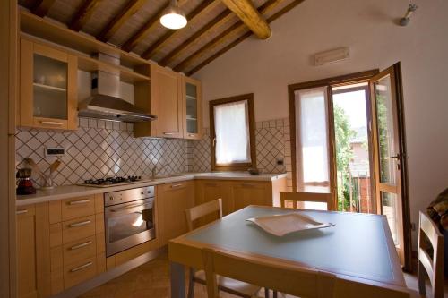 a kitchen with a wooden table and a table and chairs at Villino Francesca in Portoferraio