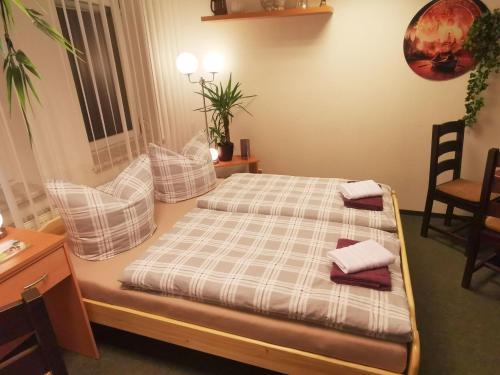 a bedroom with a bed with two pillows on it at Gästezimmer- und Ferienzimmer Am Gewölbekeller Meißen in Meißen