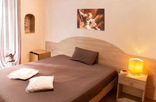 A bed or beds in a room at Camere al Santuario-Gli Arcangeli
