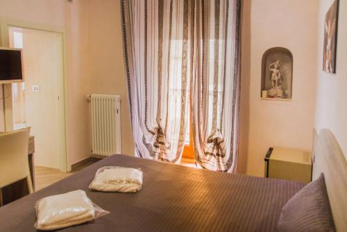 A bed or beds in a room at Camere al Santuario-Gli Arcangeli