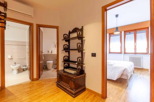 a room with a bed and a bathroom with a mirror at Attico in Centro a Belluno - Marmolada in Belluno