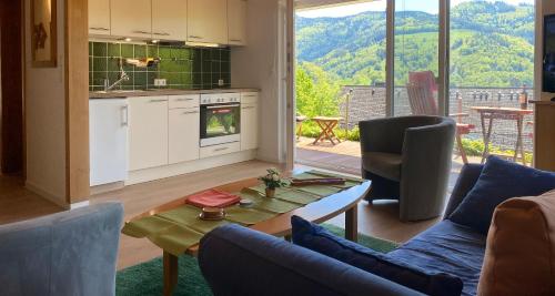 a kitchen and living room with a table and chairs at Ferienwohnung Traumblick in Schönau im Schwarzwald