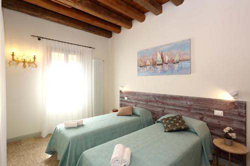 Posteľ alebo postele v izbe v ubytovaní Ca' del Pittor Apartments