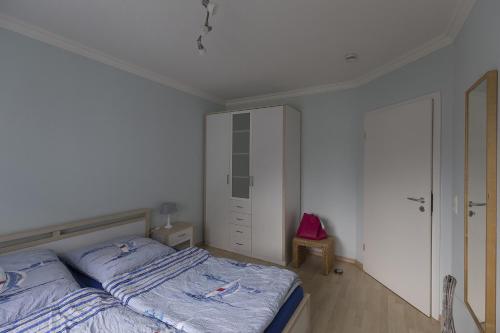 a bedroom with a bed and a dresser at An der Alten Rotbuche, Whg 3 in Zingst