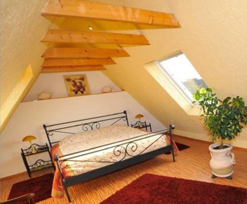 a bedroom with a bed in a attic with a window at Deluxe Apartments Bremen Typ D in Bremen