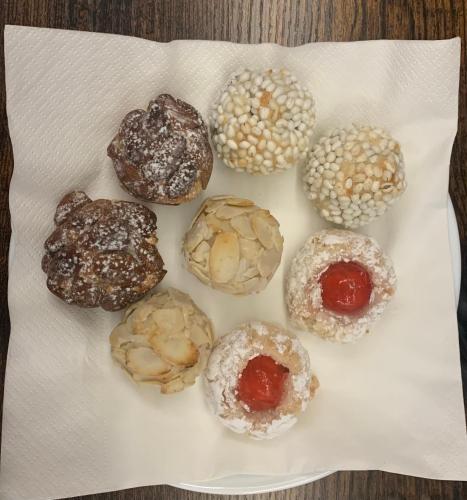 a white plate with different types of donuts on it at B&B D'Amari Affittacamere in Palermo