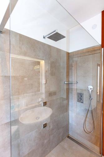 a bathroom with a sink and a shower at Attico Panoramico in Centro - Civetta in Belluno