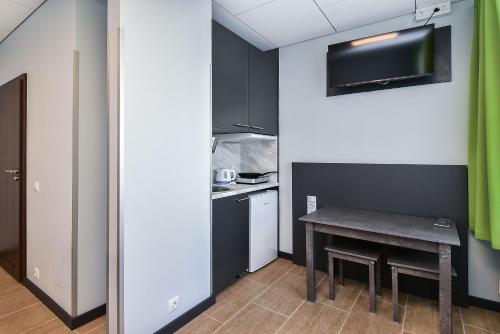 a small kitchen with a table in a room at City Yard Inn Hotel in Tallinn