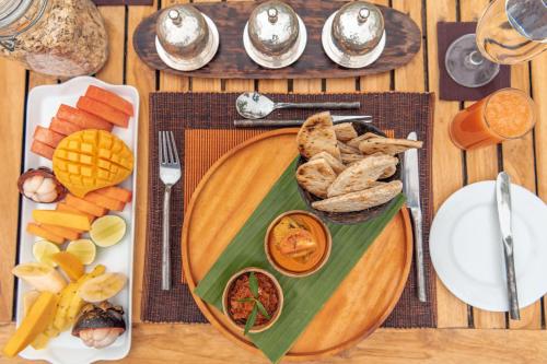 a wooden table with a plate of food on it at Leopard Safaris Yala in Yala