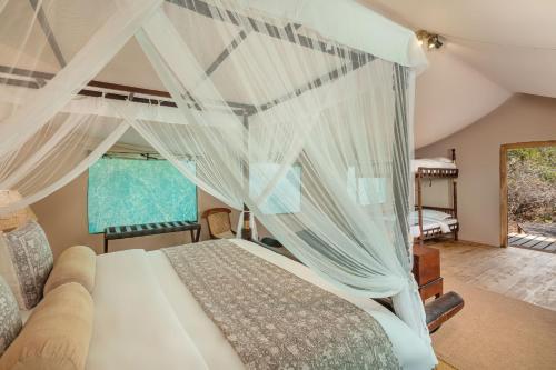 a bedroom with a bed with a canopy at Leopard Safaris Yala in Yala