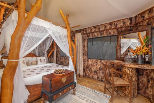 a bedroom with a bed and a desk in a room at Leopard Safaris Yala in Yala
