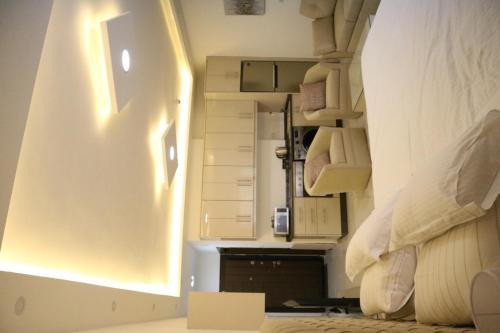 a bedroom with a bed and a wall with shelves at Amazing one Bedroom Apartment in Amman Elwebdah 5 in Amman