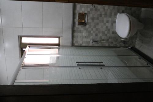 a bathroom with a sink and a toilet in a room at Amazing one Bedroom Apartment in Amman Elwebdah 5 in Amman