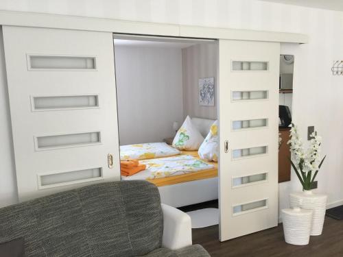 a bedroom with a bunk bed with a sliding door at Ferienwohnung Marschall in Heiligenhafen