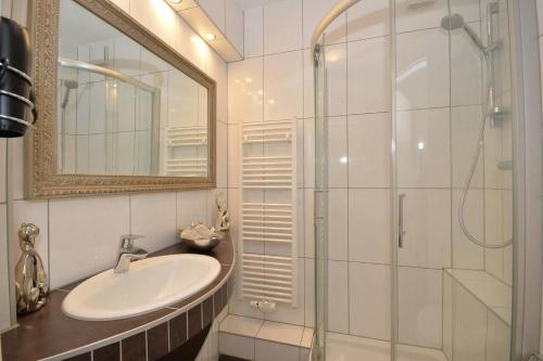 a bathroom with a sink and a shower with a mirror at Business Apartments Bremen Typ 2 in Bremen