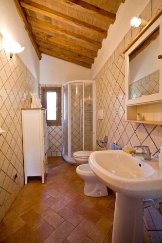 a bathroom with two toilets and a sink and a mirror at Villino Francesca in Portoferraio
