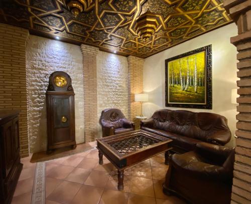 a living room filled with furniture and a fire place at Hostal Rodri in Granada