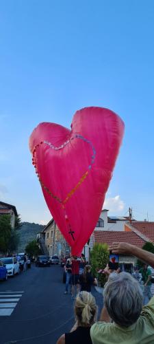 a large pink heart balloon in a parking lot at Casa elisa in Dolcedo
