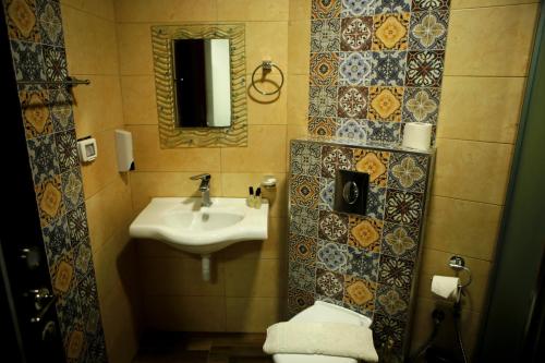 une salle de bain avec un lavabo et des toilettes dans l'établissement Alrowwad Guest House, à Bethléem