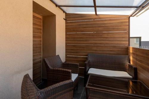 a room with two chairs and a table and a wall at Apartmán Trenčan in Považská Bystrica