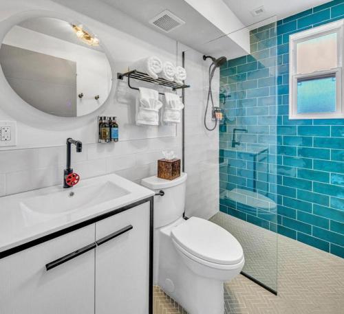 a bathroom with a sink, toilet and shower at The Saint Hotel in St Pete Beach