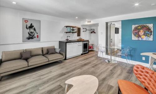a living room with a couch and a kitchen at The Saint Hotel in St Pete Beach