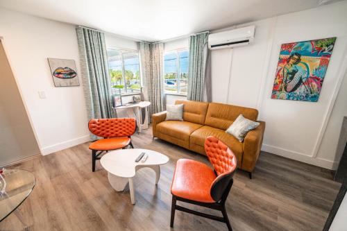 a living room with a couch and chairs and a table at The Saint Hotel in St Pete Beach