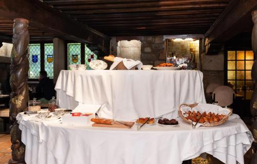 a white table with plates of food on it at Hôtel La Gentilhommière in Nuits-Saint-Georges